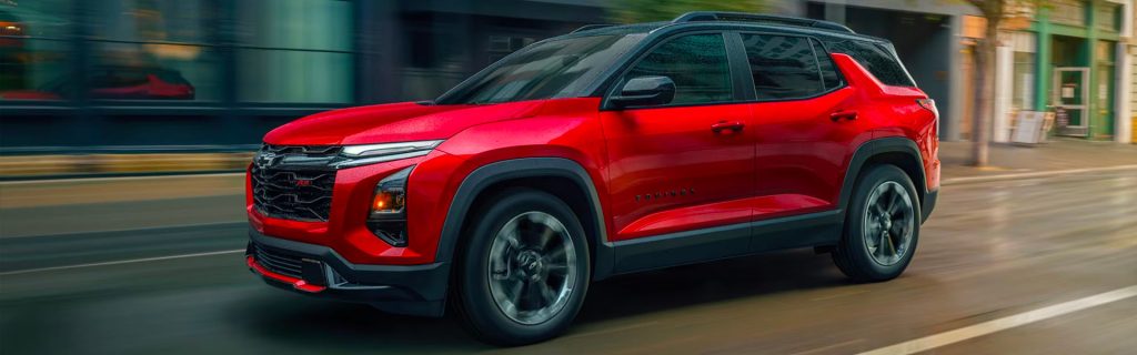 2026 Chevrolet Equinox Red driving through a city street.